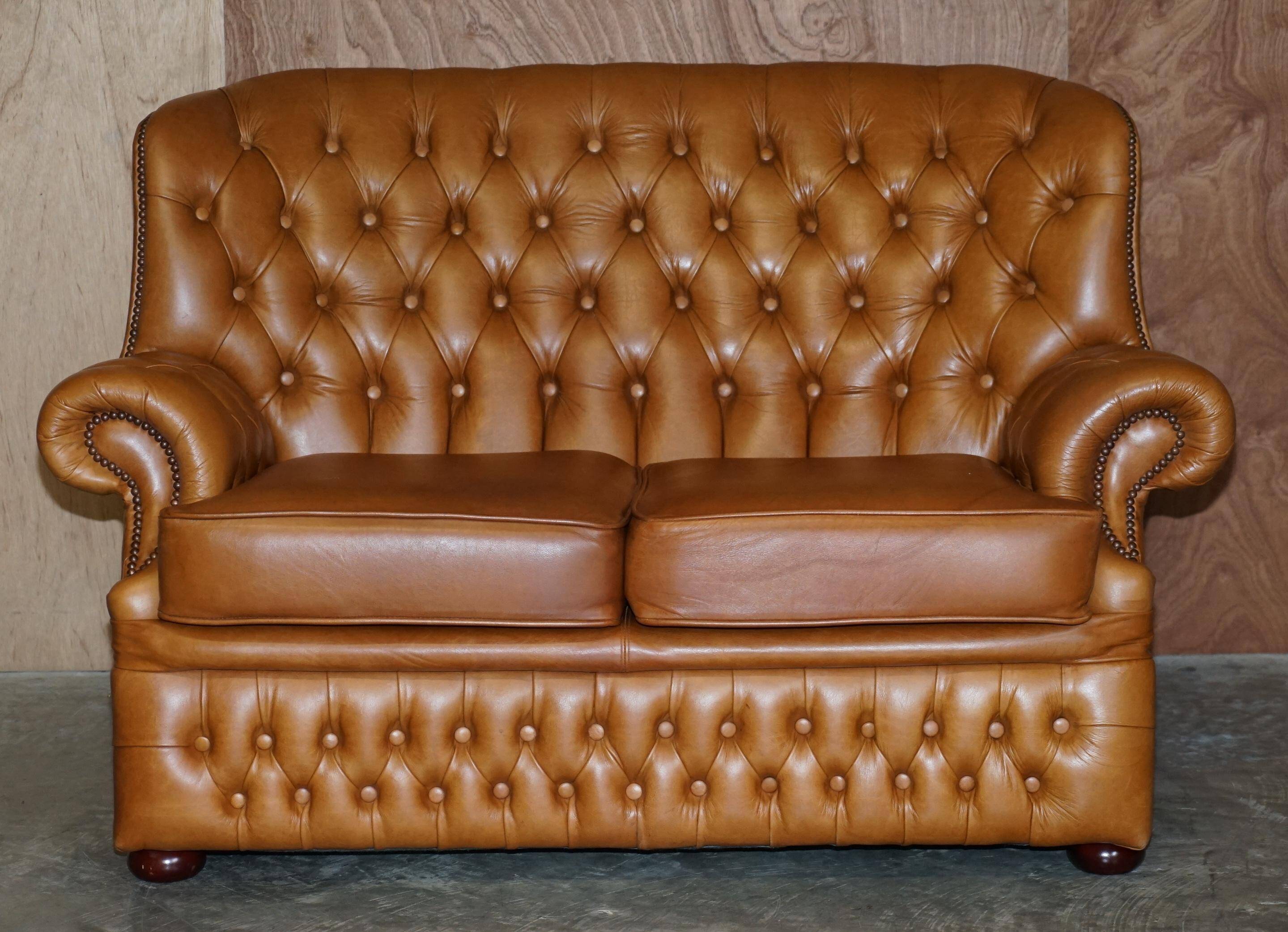 Small Chesterfield leather sofa with a high back.
