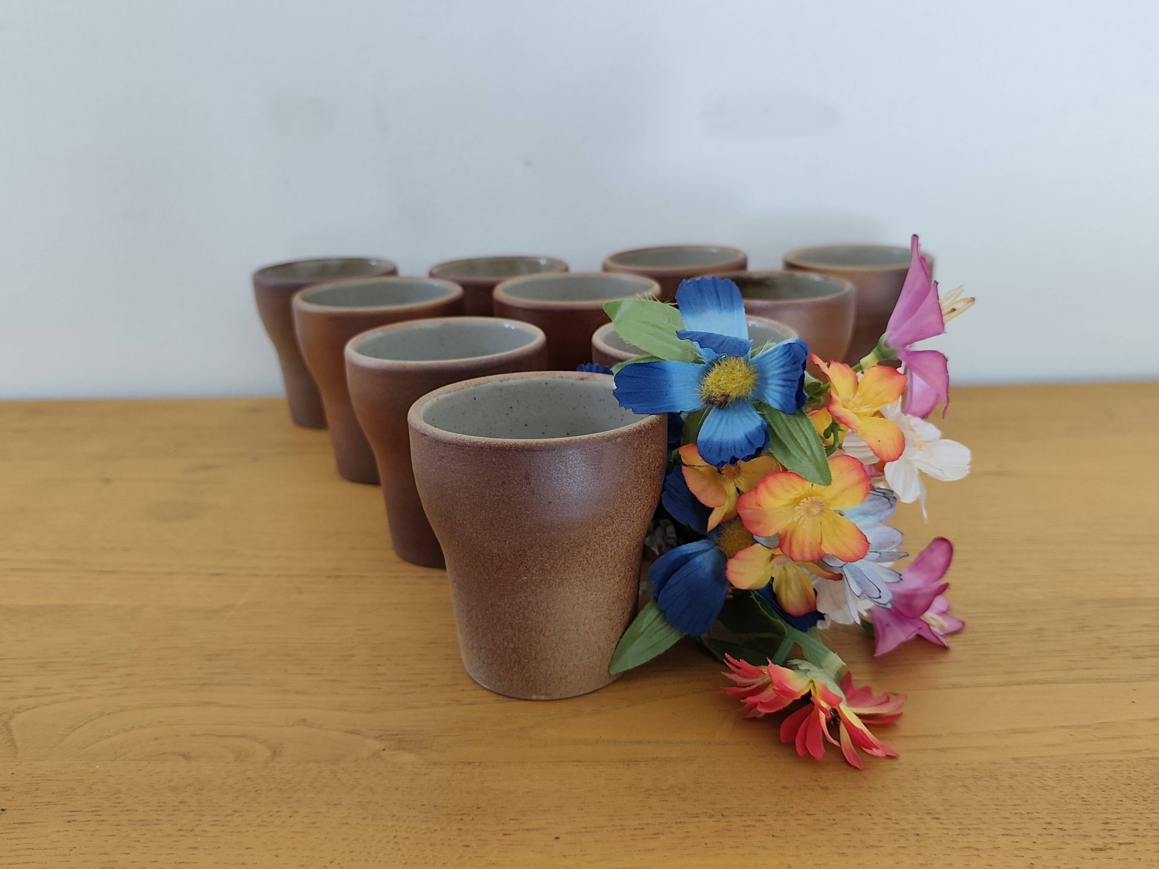 Stoneware cups – Armor stoneware set of 10 and an 11th French stoneware cup.