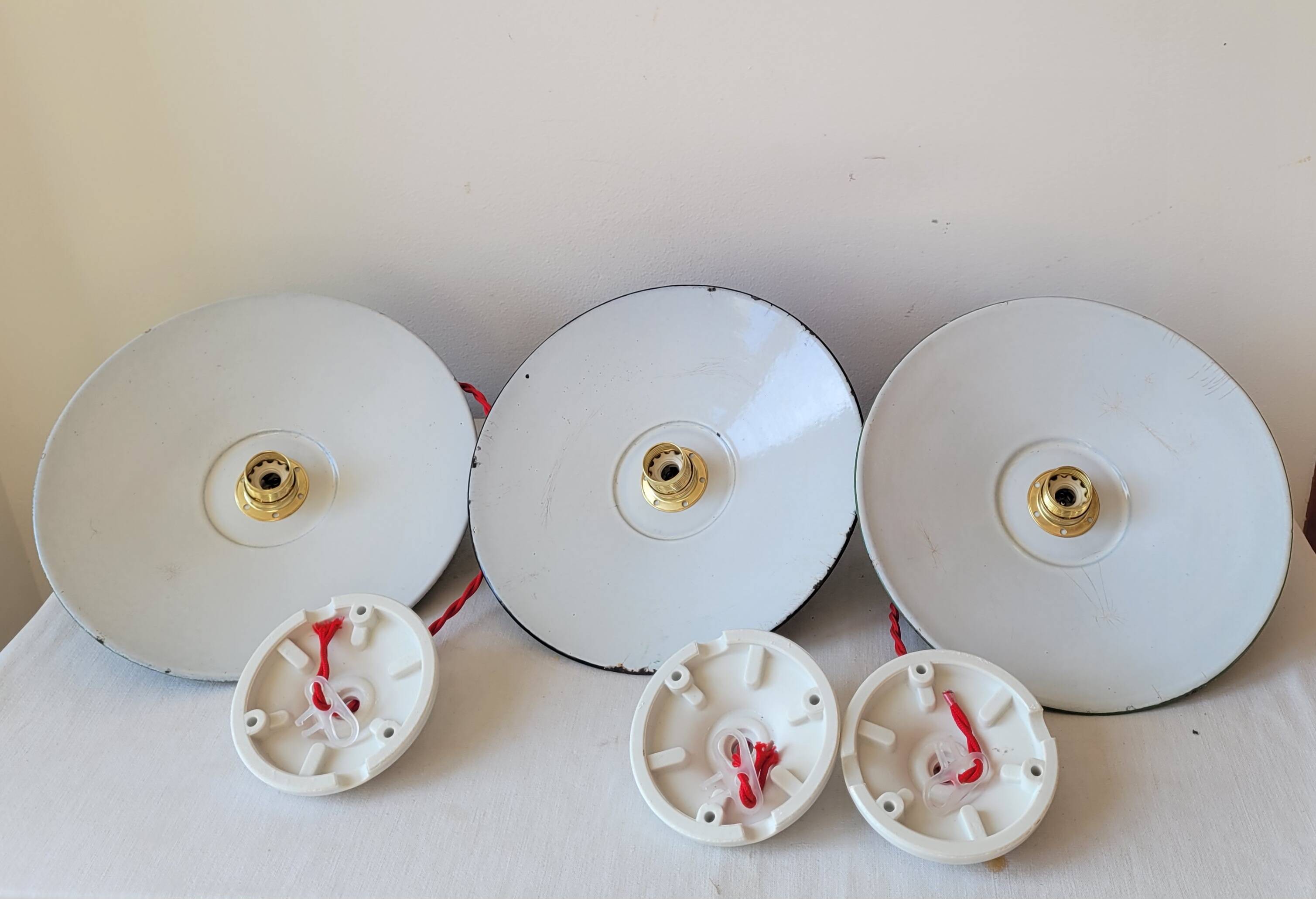 Trio of enameled sheet metal pendant lights