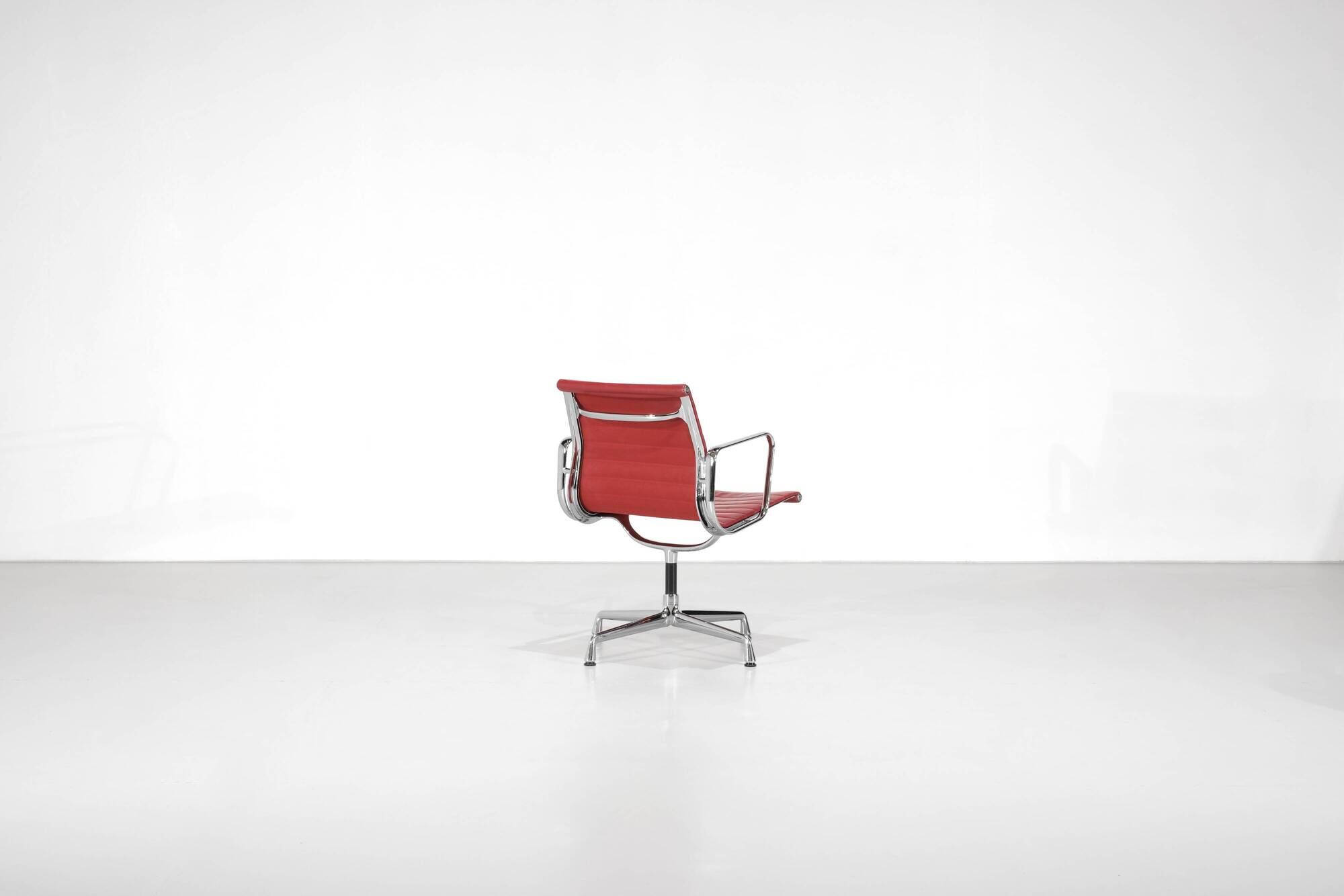 "EA 108" armchair in red leather, designed by Charles and Ray Eames for Vitra,