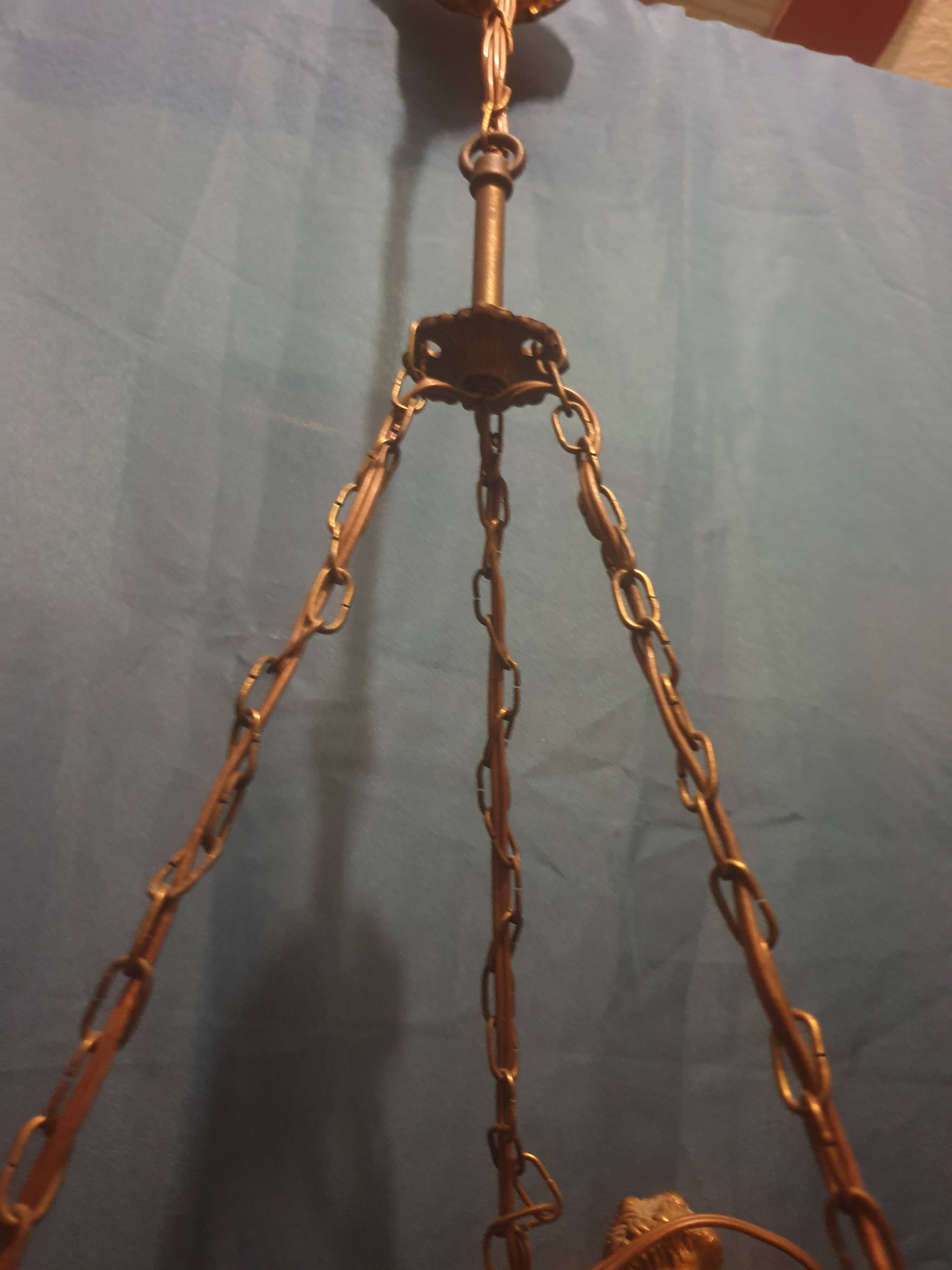 Antique chandelier decorated with cherubs and putti angels taken from the attic