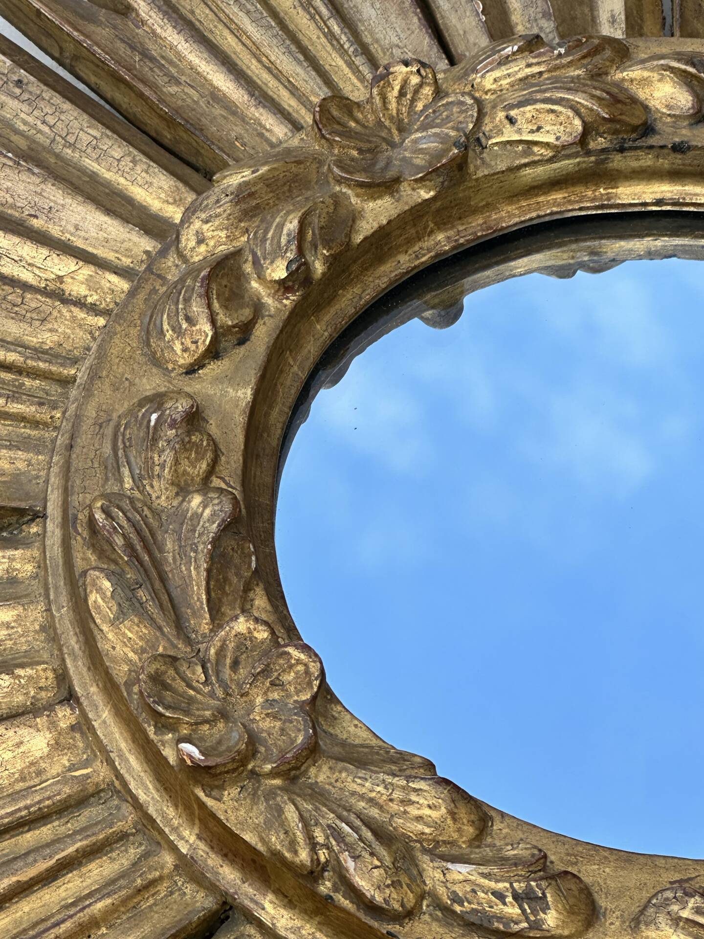 Large sun mirror in carved gilded wood.