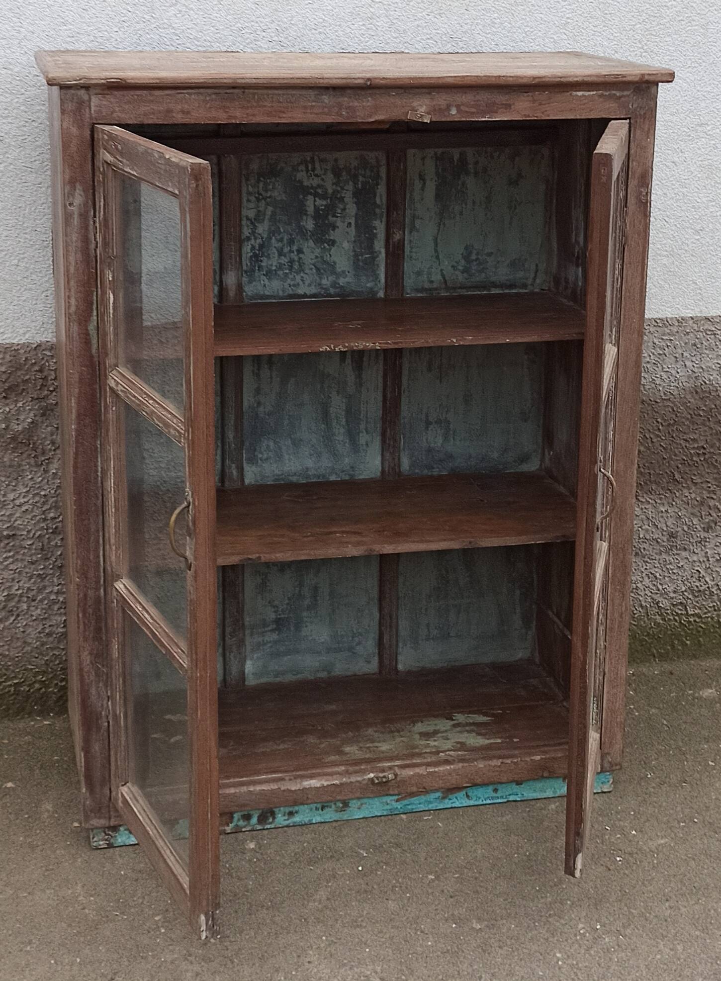 Old glazed wooden cabinet with metal bottom