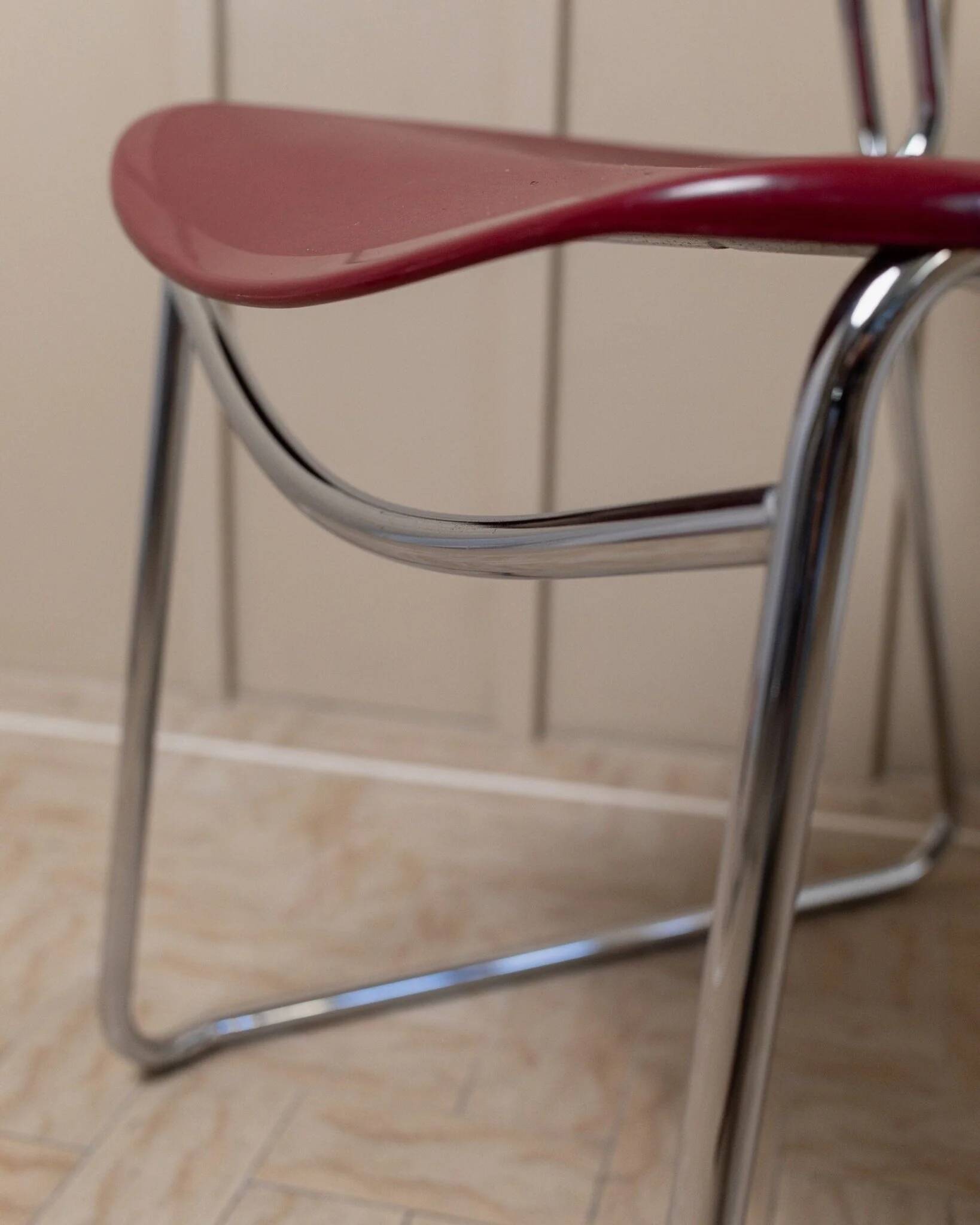 Red plastic-seat stacking chair with chrome frame by Paolo Favaretto for Assisa (Italy 1986) – vintage design