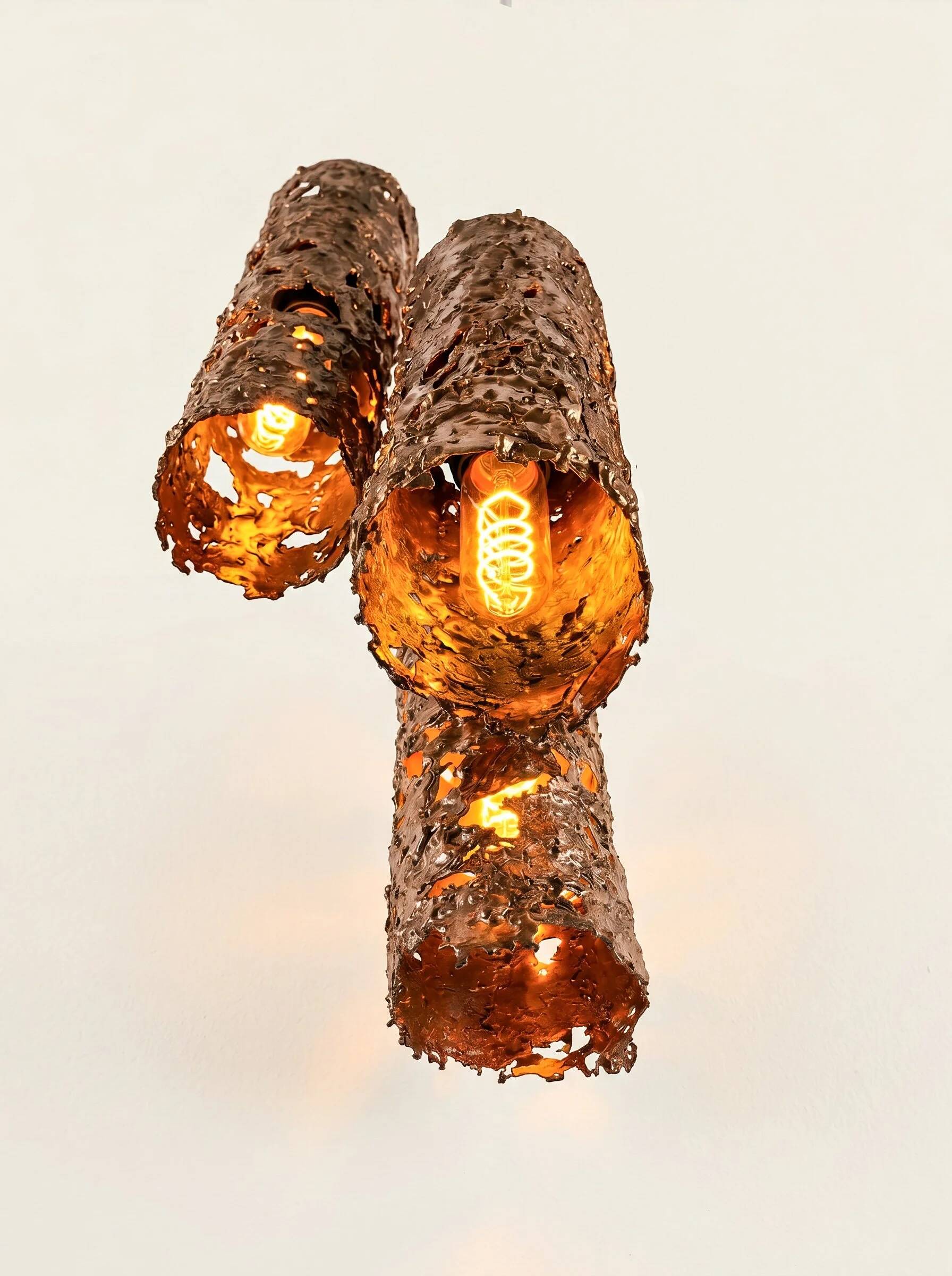 Suspension composed of 3 brutalist copper lamps by Aimo Tukiainen, 1960s.