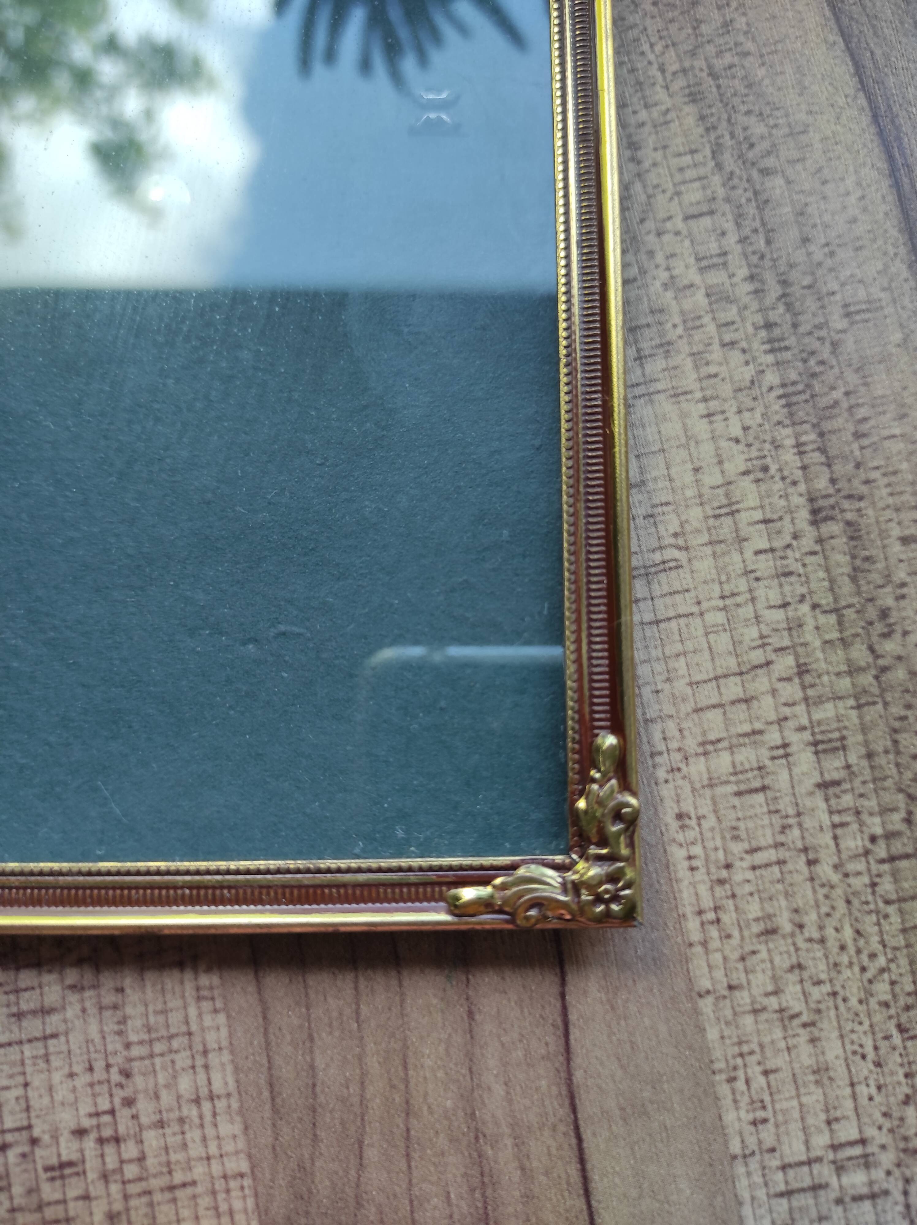 Vintage photo frame in gold and decorated metal