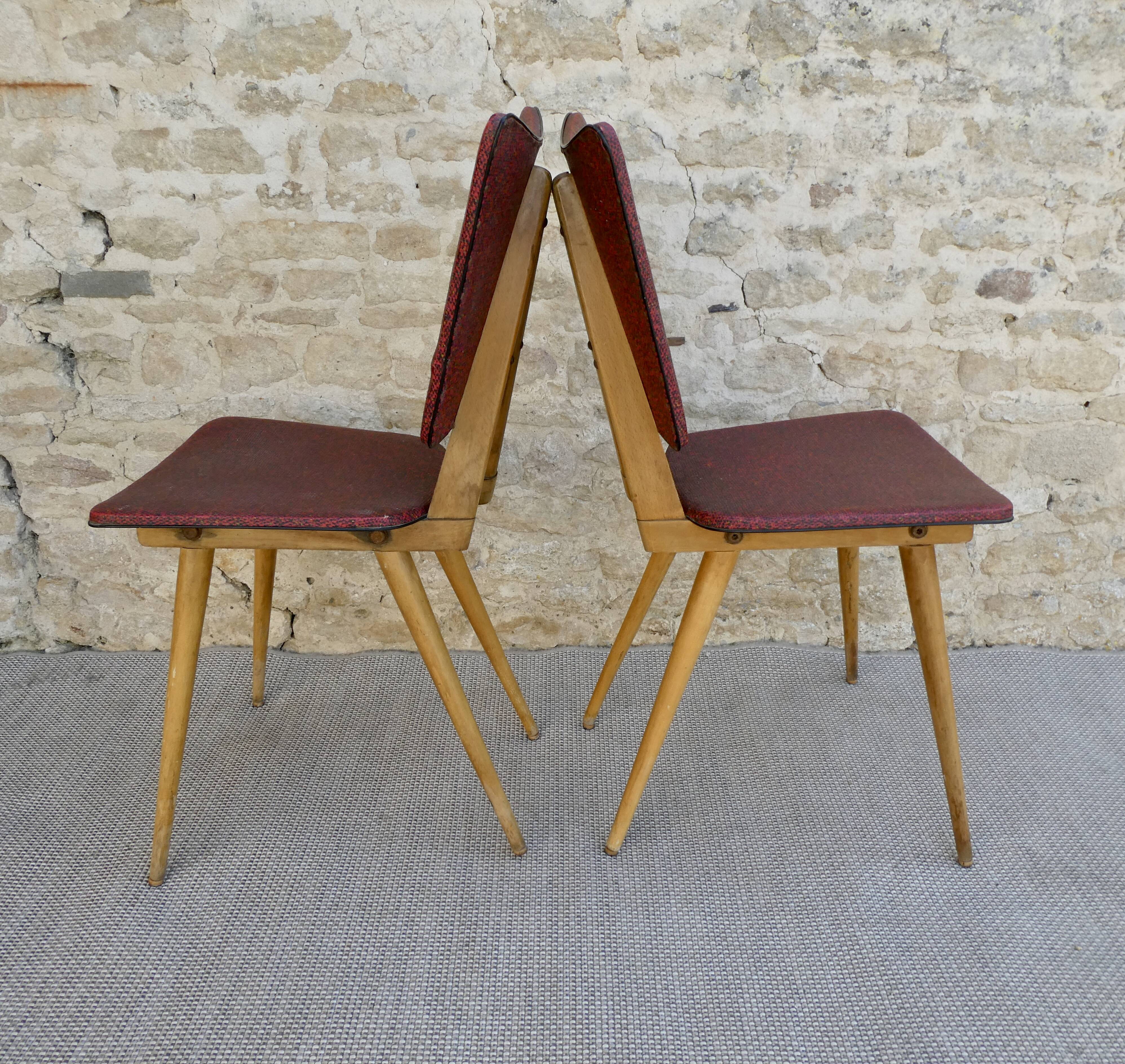 Pair of wooden chairs and red skai, 50s