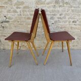 Pair of wooden chairs and red skai, 50s