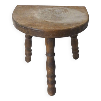 Old milking bench tripod stool in solid wood