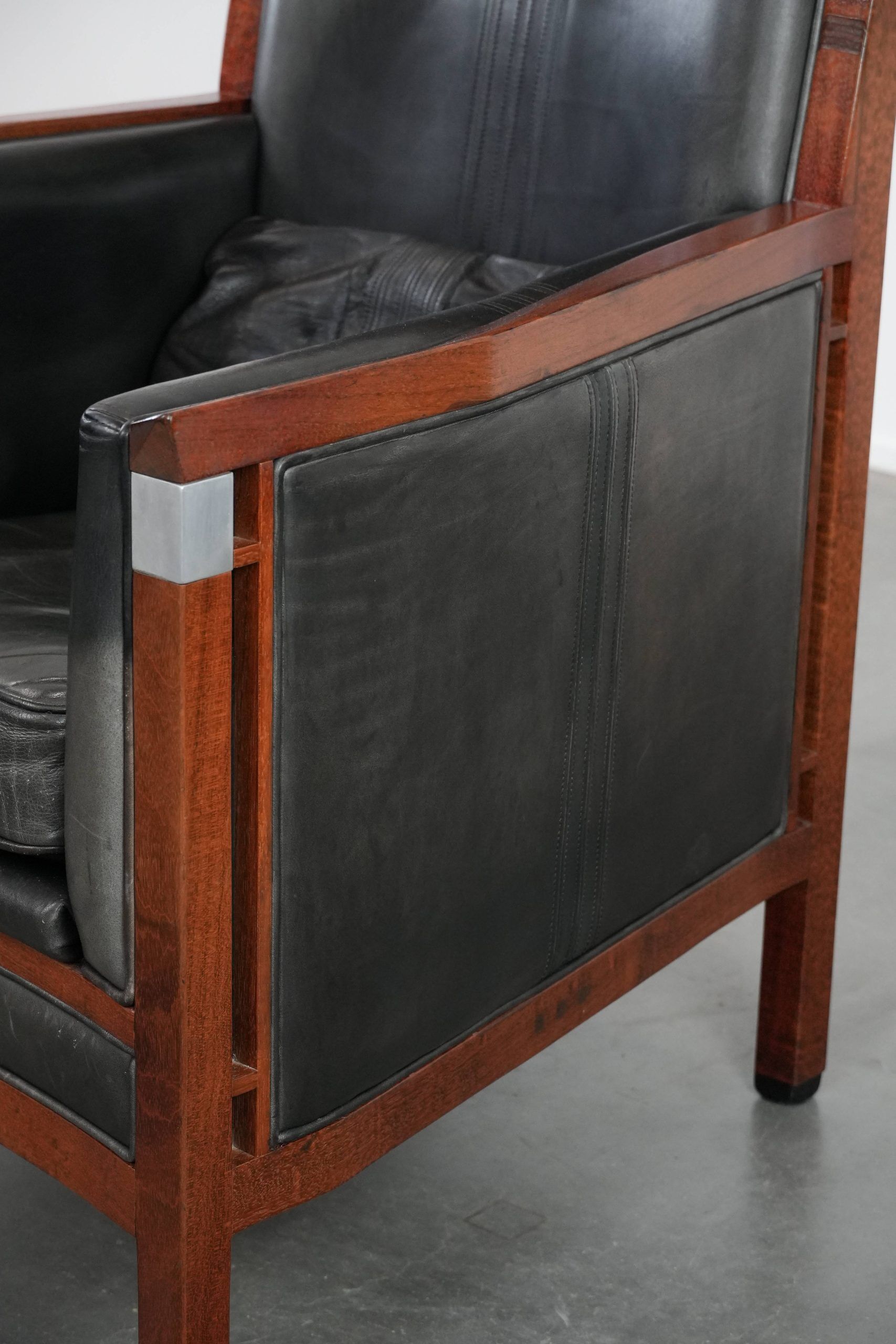 Black Art Deco cowhide leather and wooden design armchair with a high back