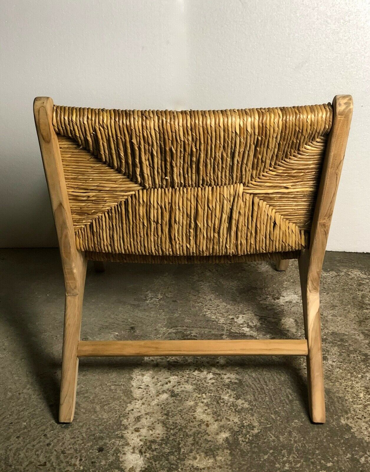 Low armchair in raw teak with seat and mulched backrest