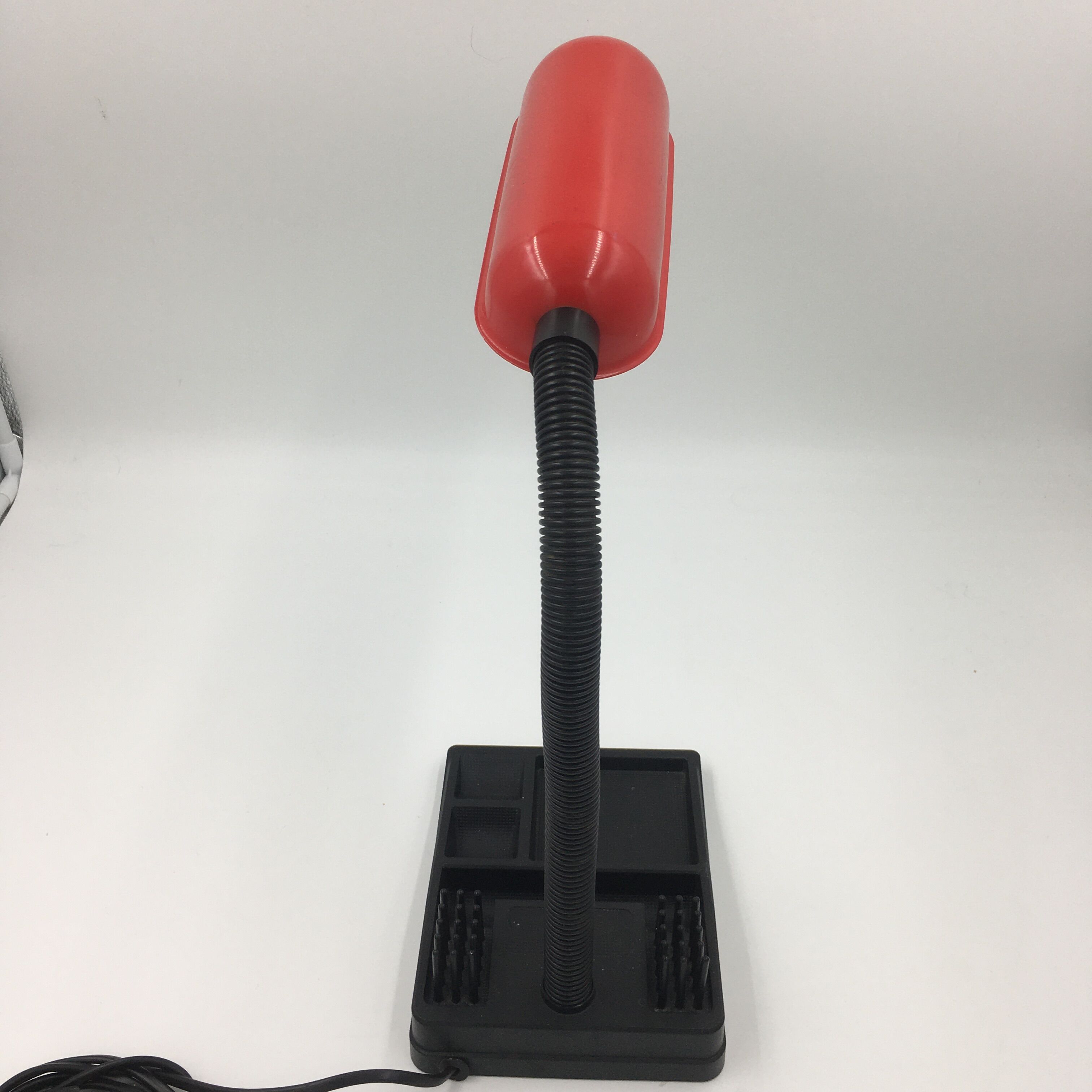 Duo of red and black flexible desk lamps with pencil holder