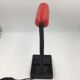Duo of red and black flexible desk lamps with pencil holder