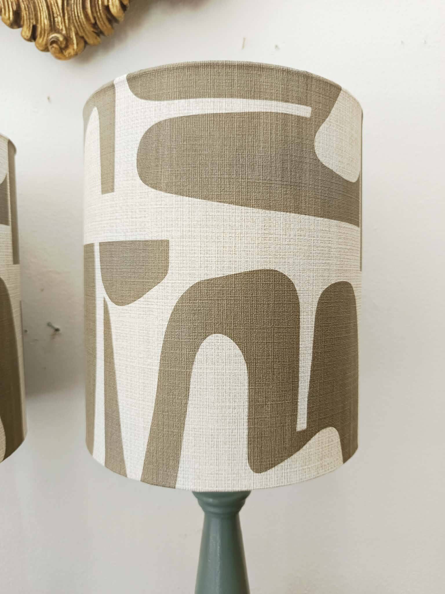 Pair of wooden lamps with custom modernist lampshades.