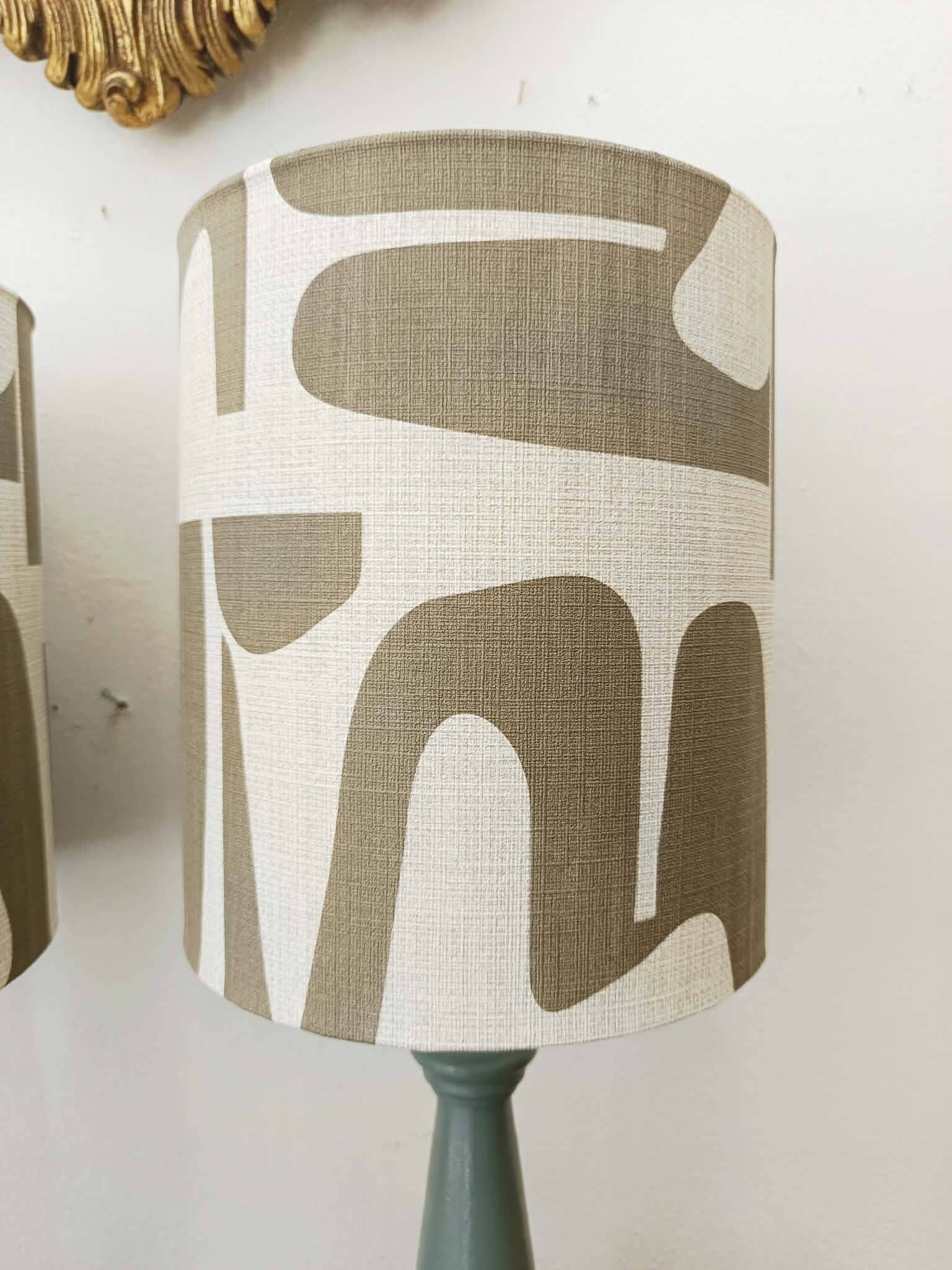 Pair of wooden lamps with custom modernist lampshades.