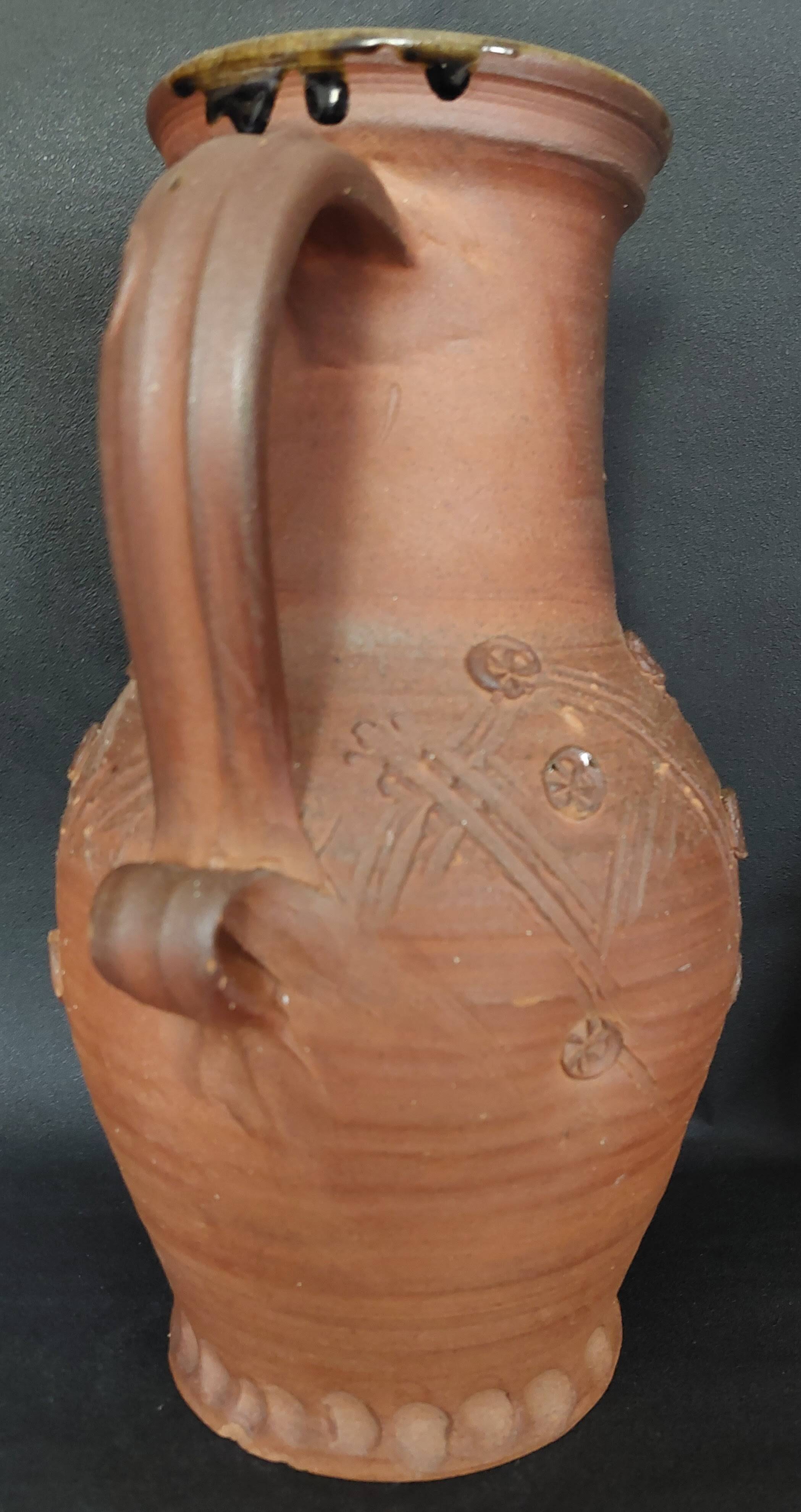 Vintage pitcher with a signature to identify.
