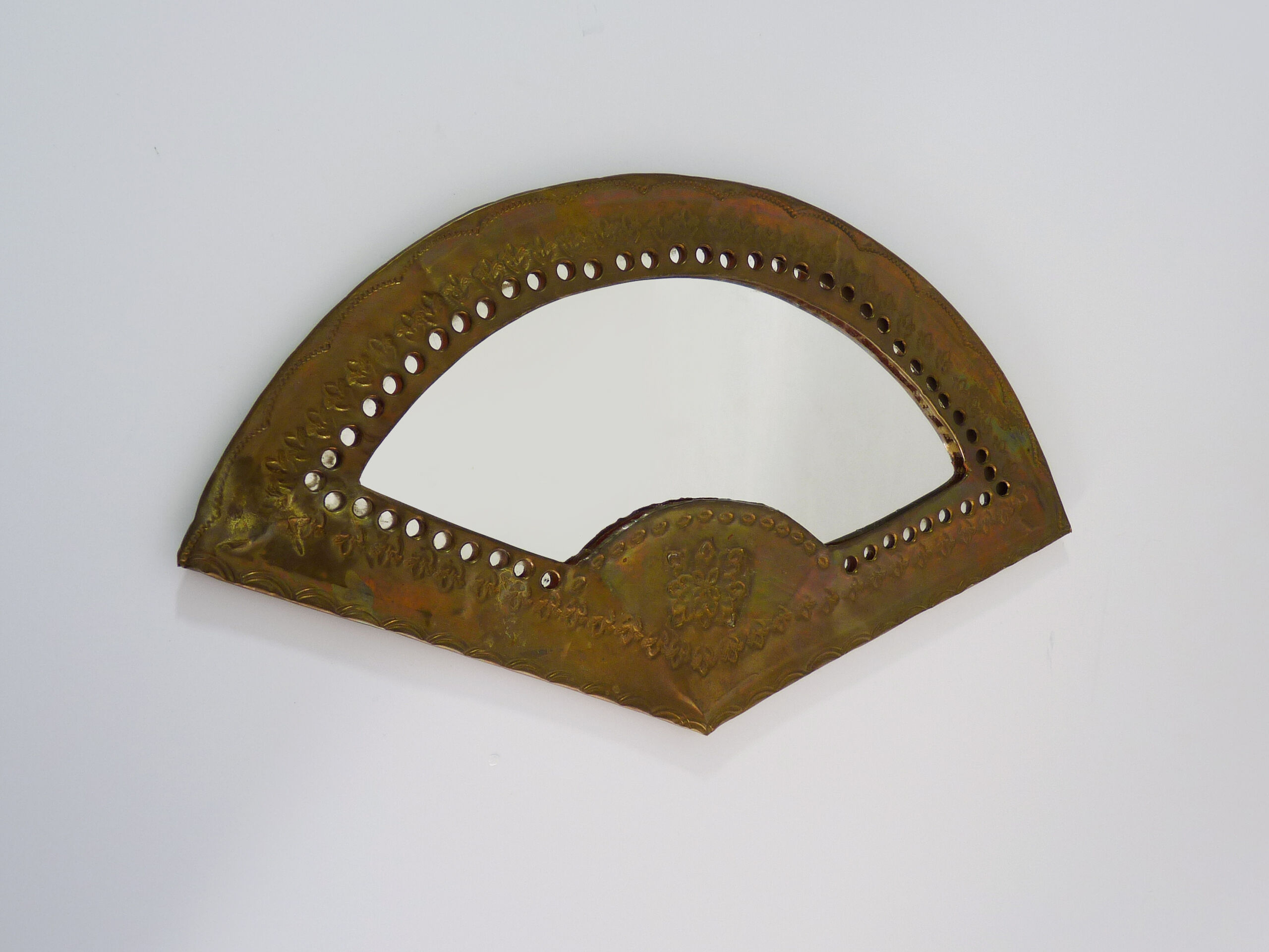 Old wall mirror in the shape of a copper fan pushed back, year 70
