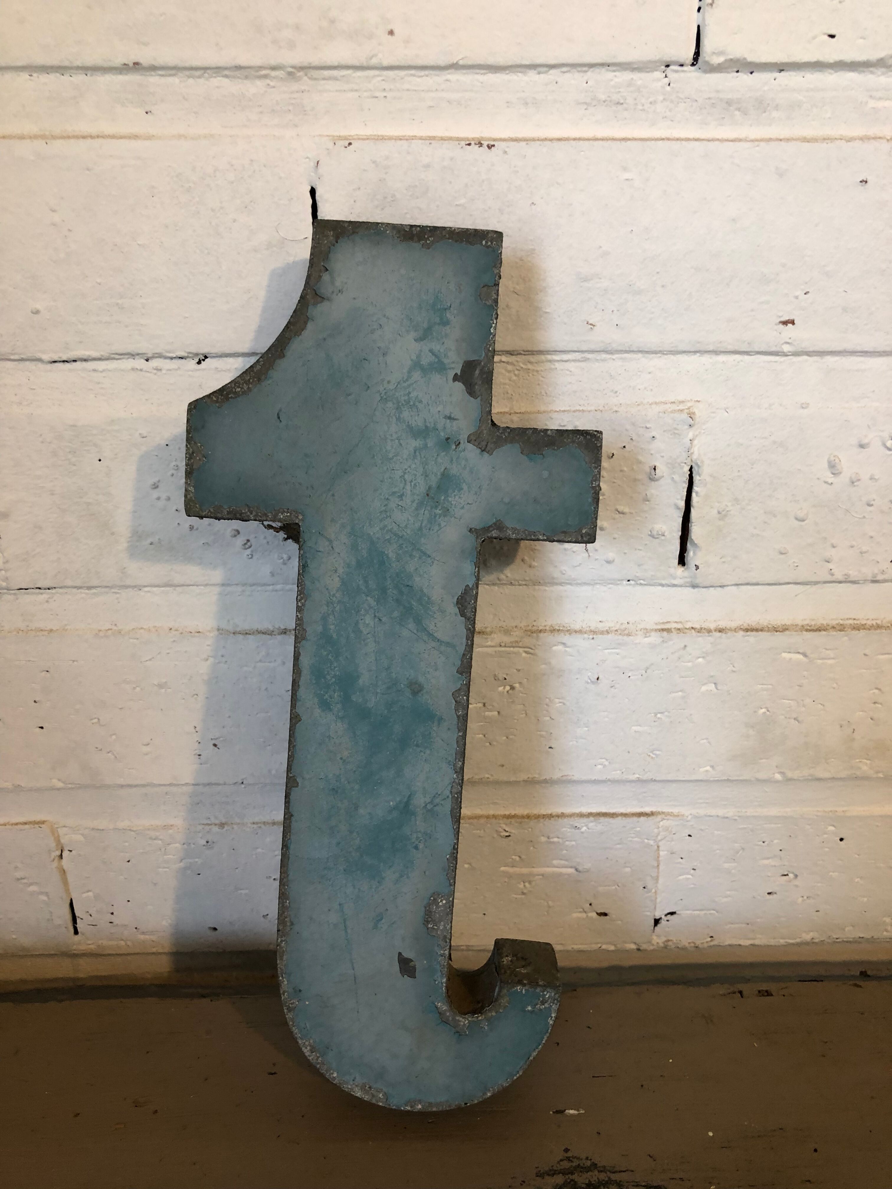 Blue sign letter "T"