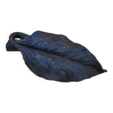 cast iron paperweight in the shape of a leaf