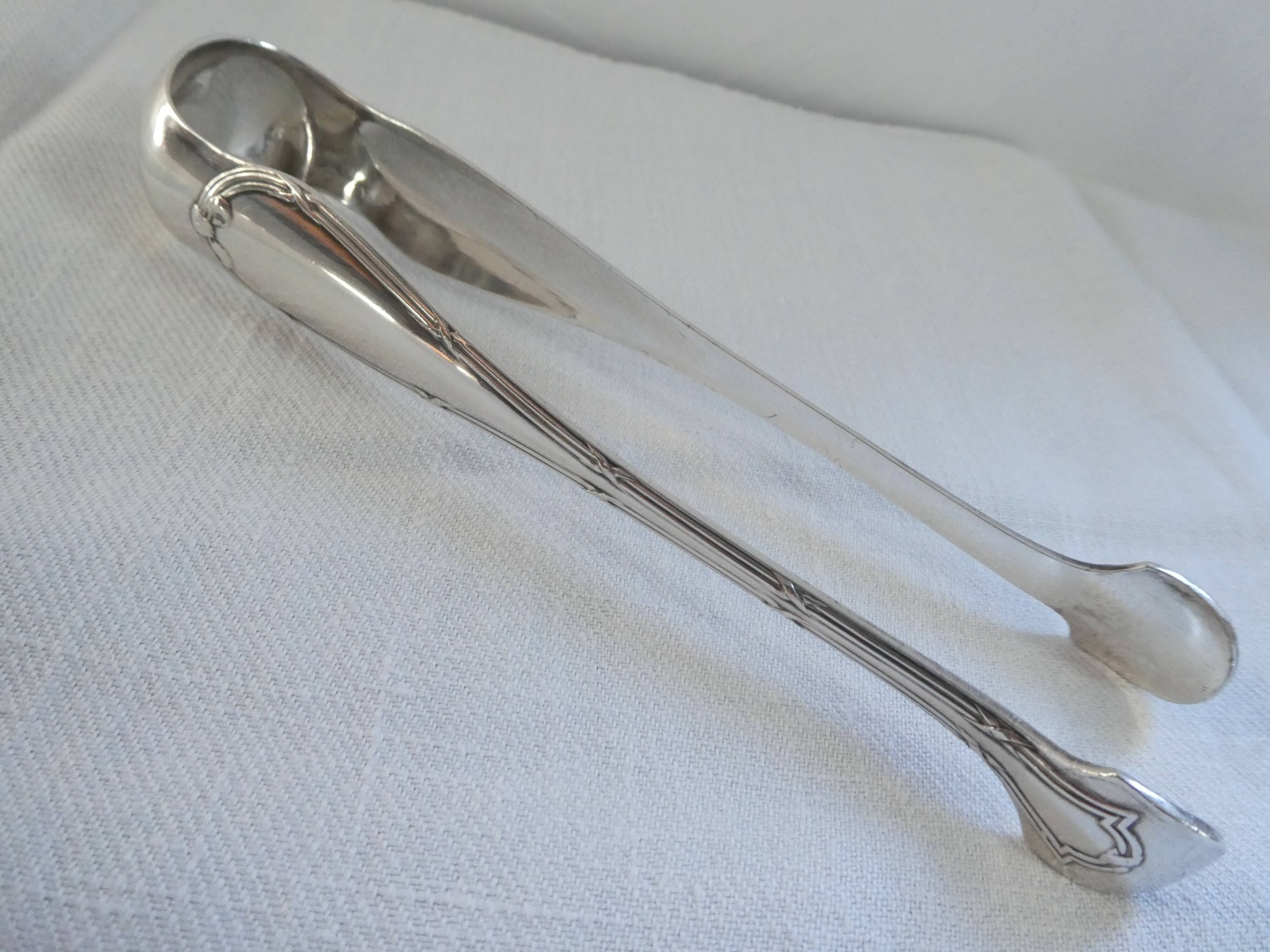 Christofle Silver-plated metal sugar tongs with crossed ribbon bow design