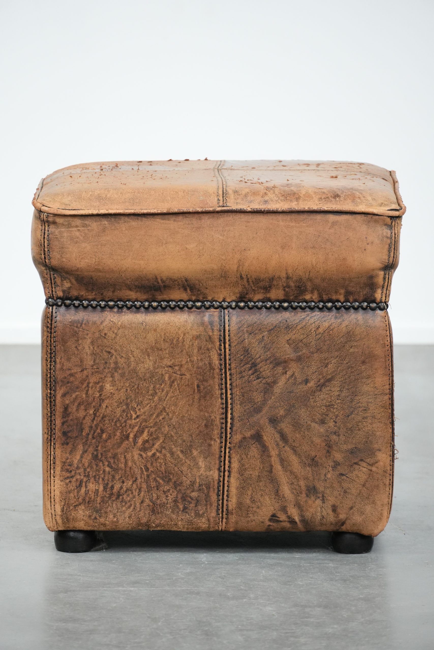 Sturdy square vintage sheepskin pouf/ottoman with beautiful colours