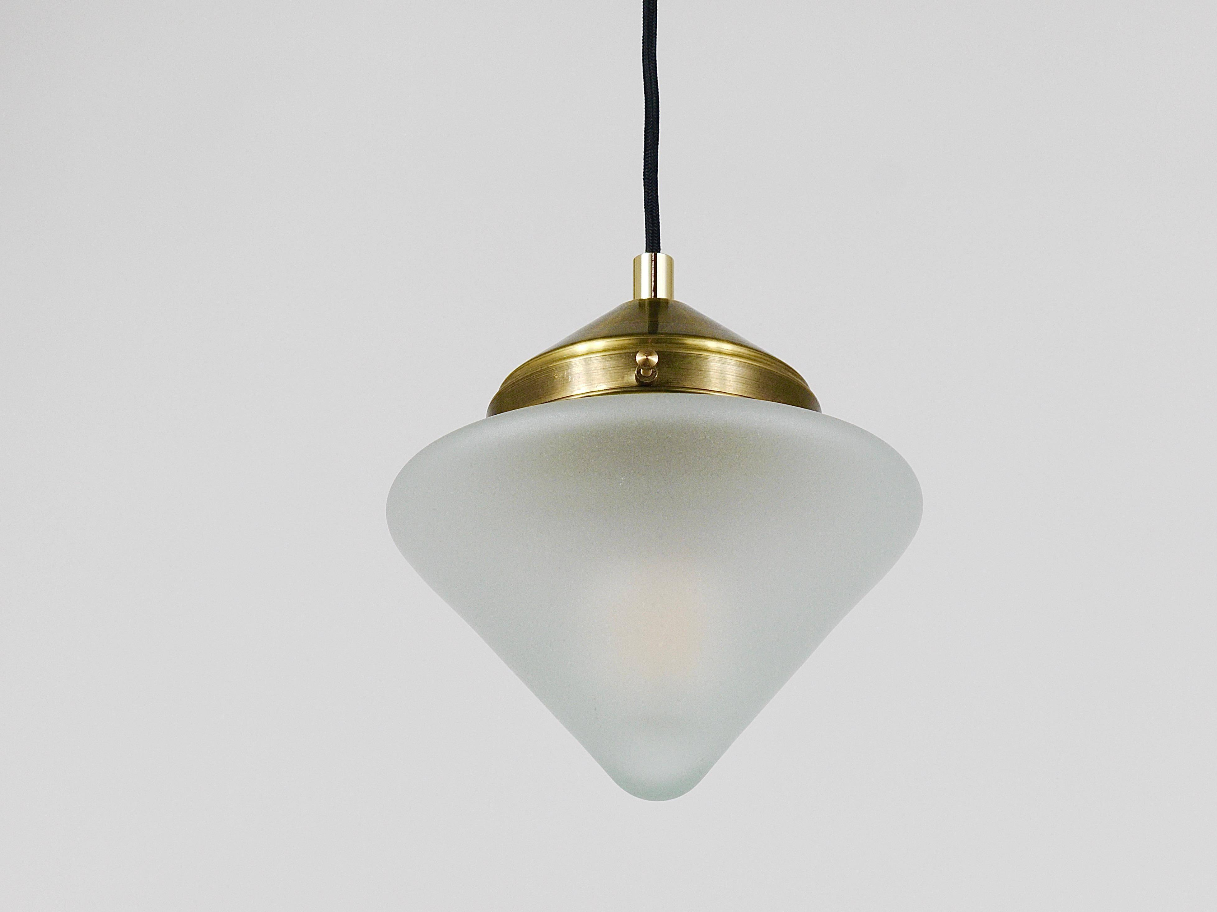 Up to 7 Art Deco brass pendant lights with conical glass shades, Vienna 1930s.