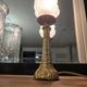 Table lamp with brass base and vintage flame globe