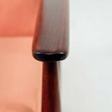 Mid-century modern armchair in coral red designed by H. Lis.