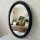 Vintage oval mirror in petrol blue wood