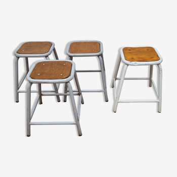 Set of four stackable tubular metal and wood industrial stools