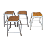 Set of four stackable industrial tubular metal and wood stools