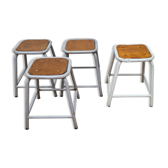 Set of four stackable tubular metal and wood industrial stools