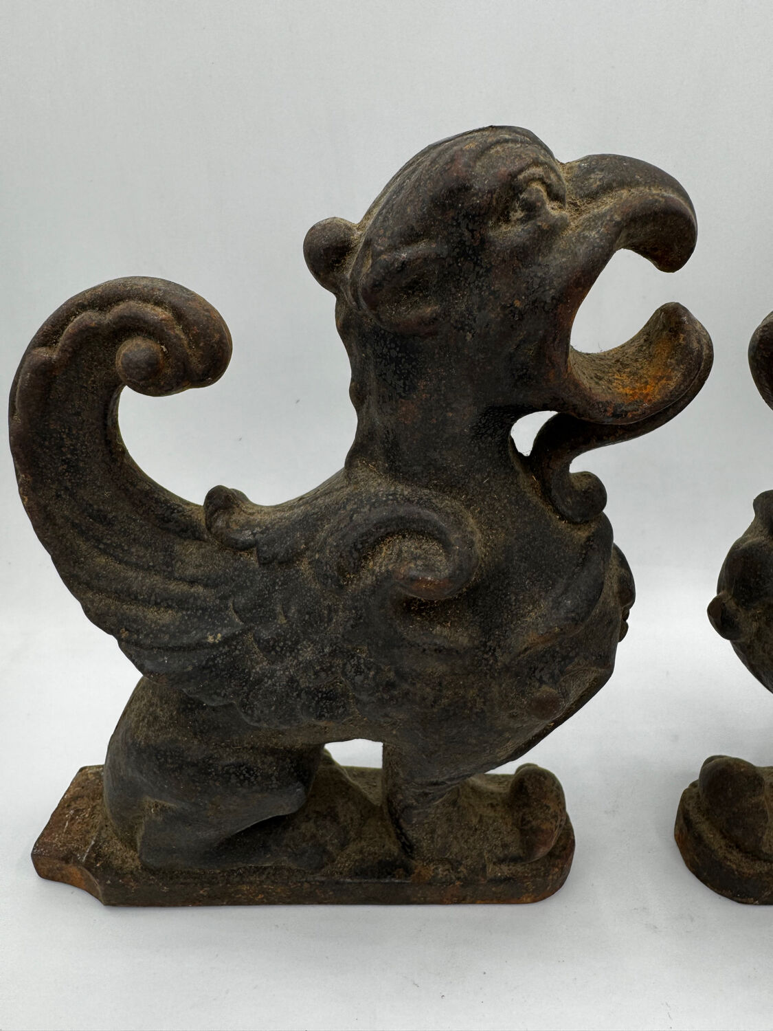 Pair of winged chimera and dragon fire dogs in cast iron