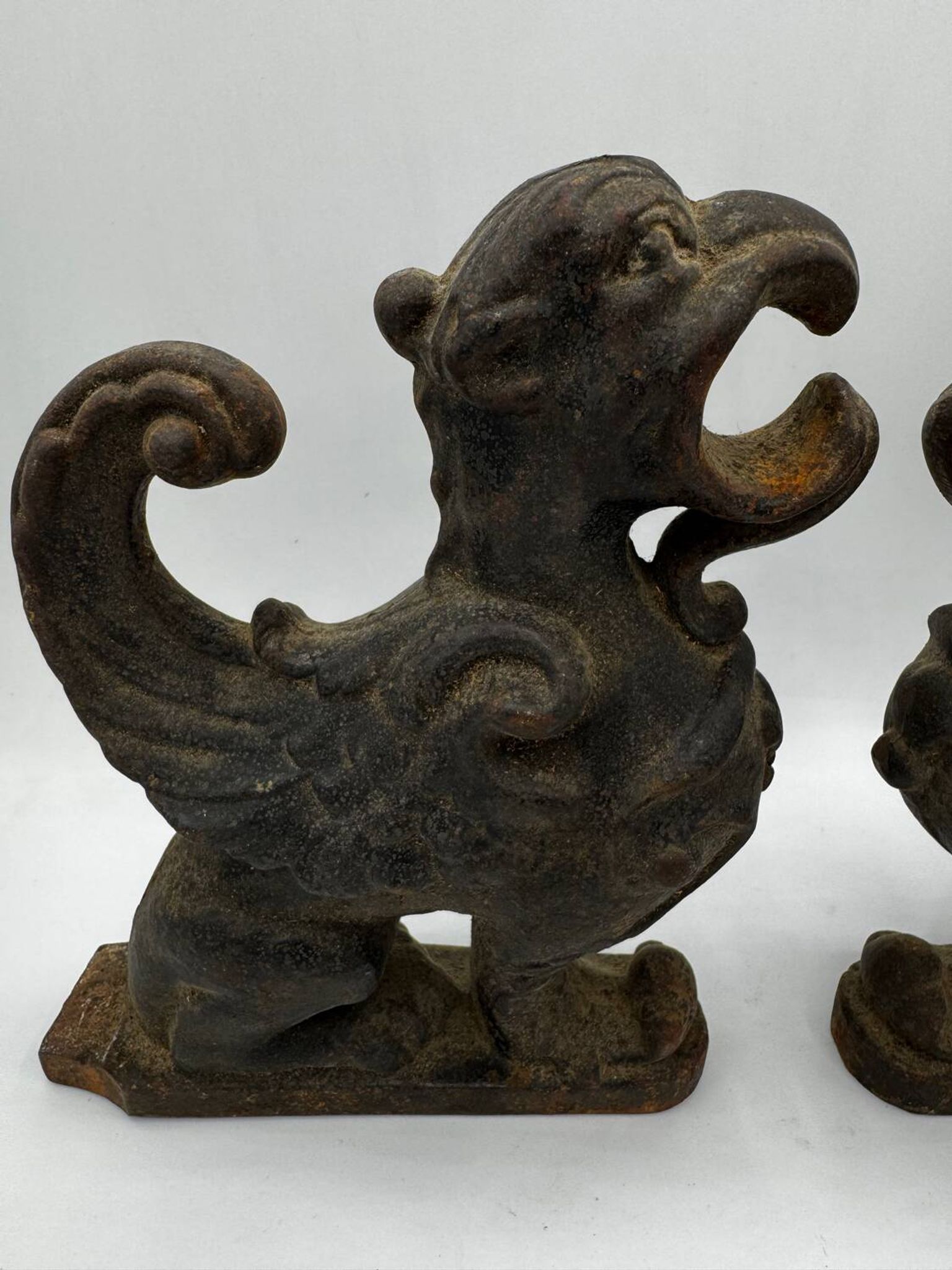 Pair of winged chimera and dragon fire dogs in cast iron