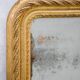 19th-century patinated mirror with a ribbon-style frame