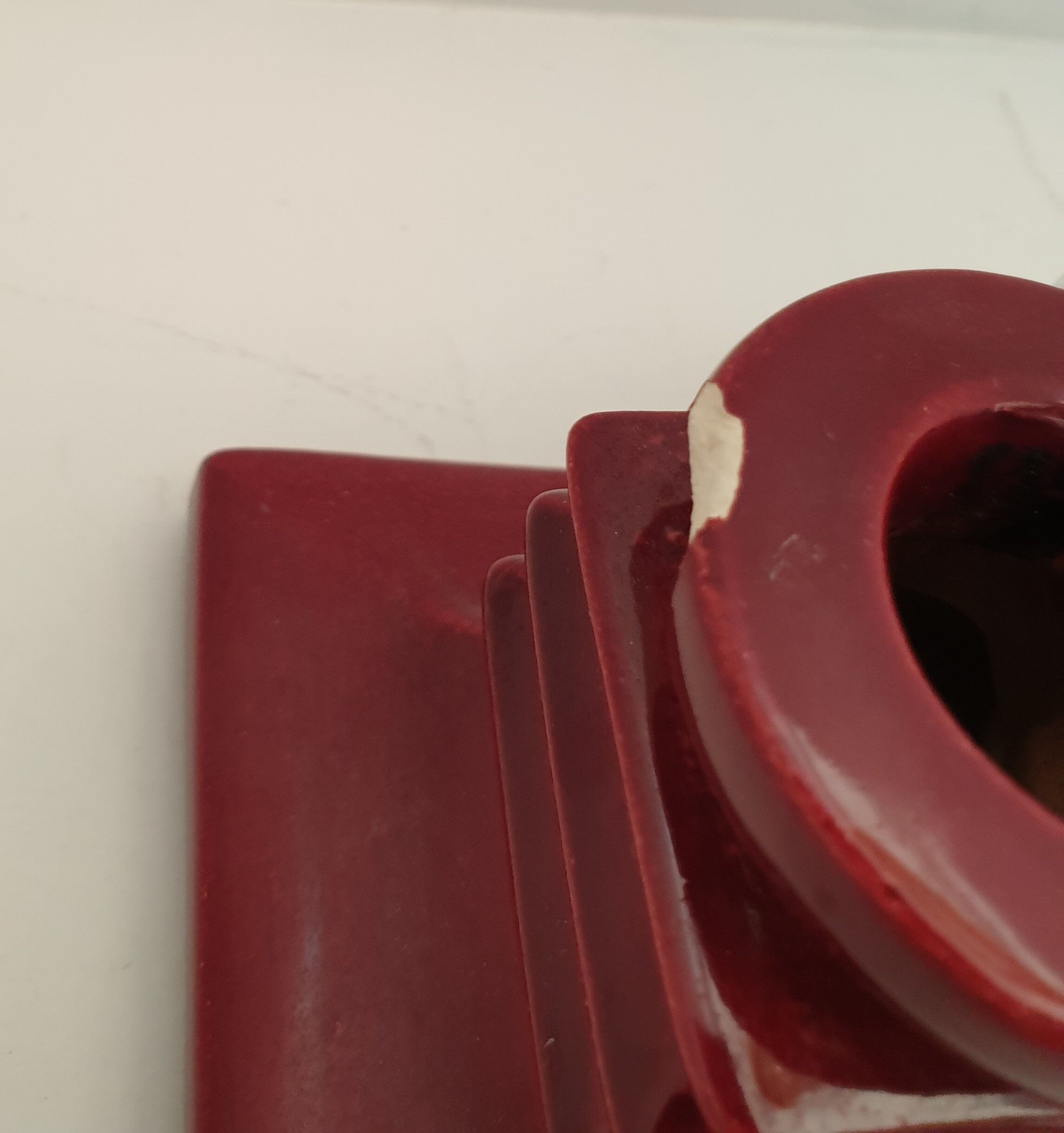 Pair of art deco candlesticks in bordeaux ceramics