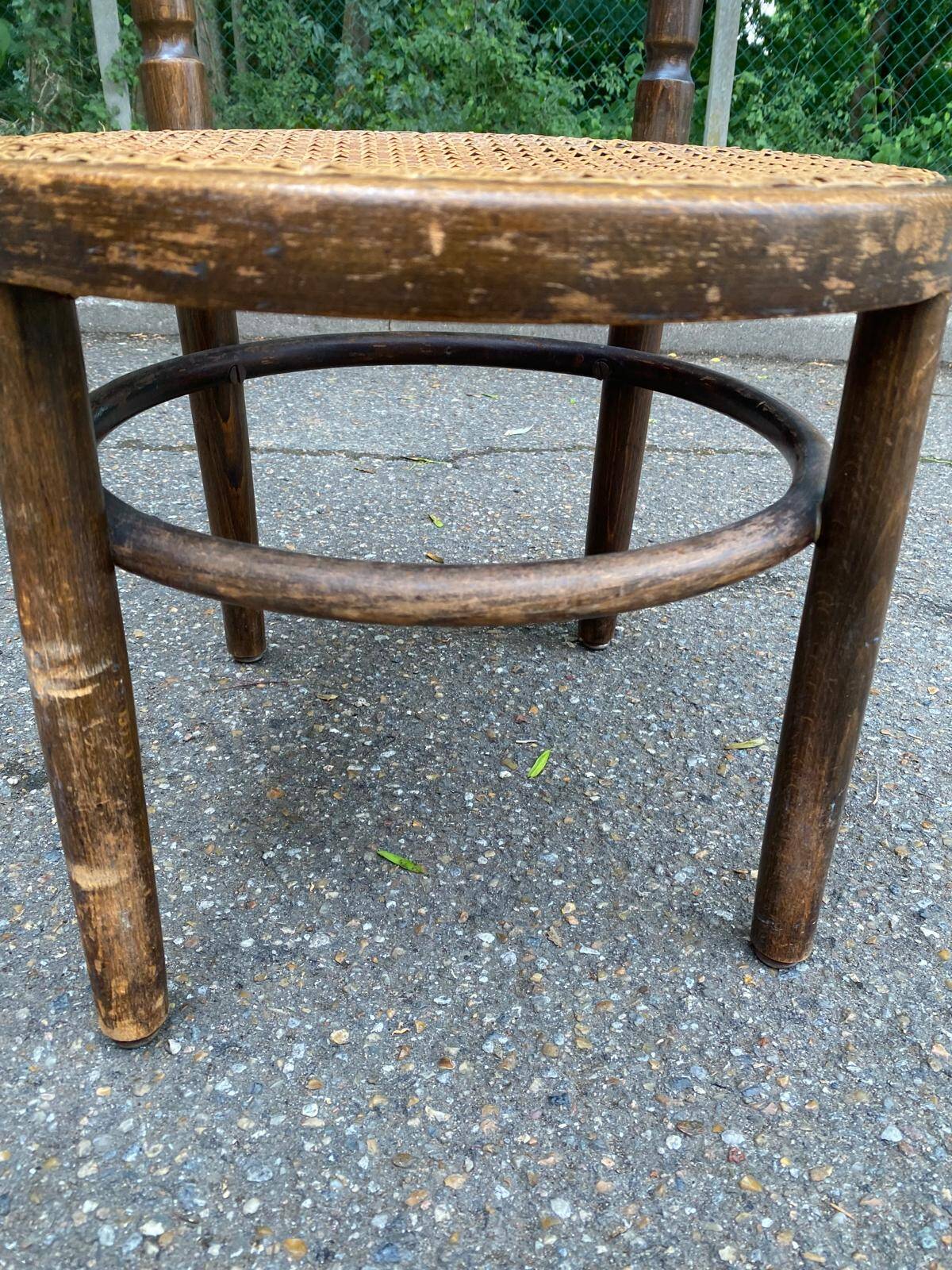Vintage 19th-century bistro chair made of curved solid wood and caned in the Thonet style.