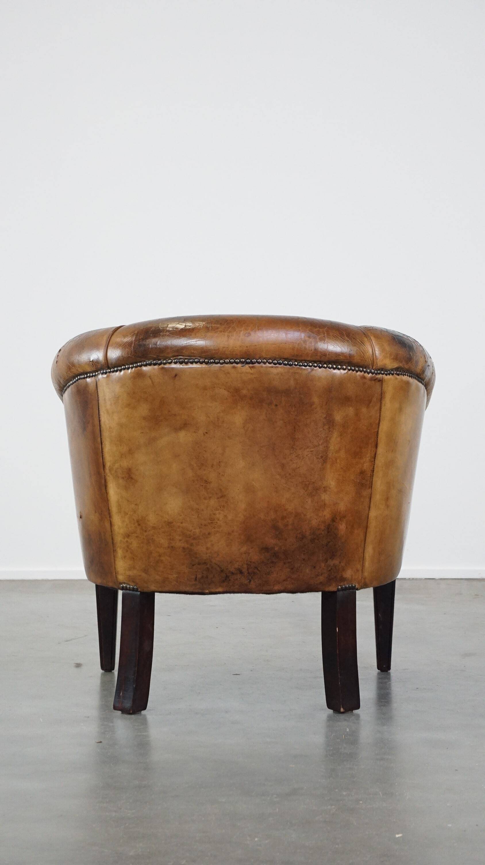 Sturdy, stately and subtle vintage sheepskin club chair