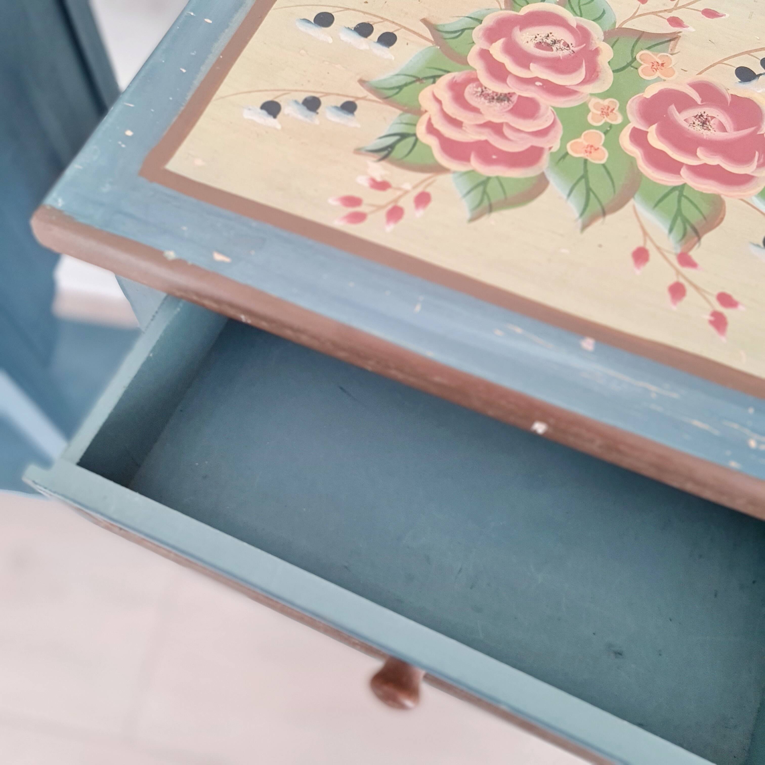 Blue wooden bedside tables with floral patterns