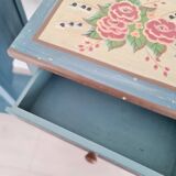 Blue wooden bedside tables with floral patterns
