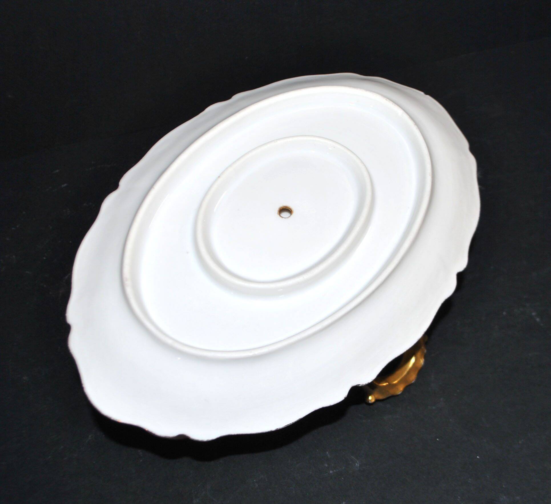 Vintage pouring sauce boat in floral porcelain with gilding.