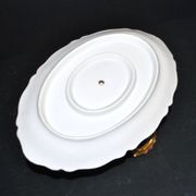 Vintage pouring sauce boat in floral porcelain with gilding.