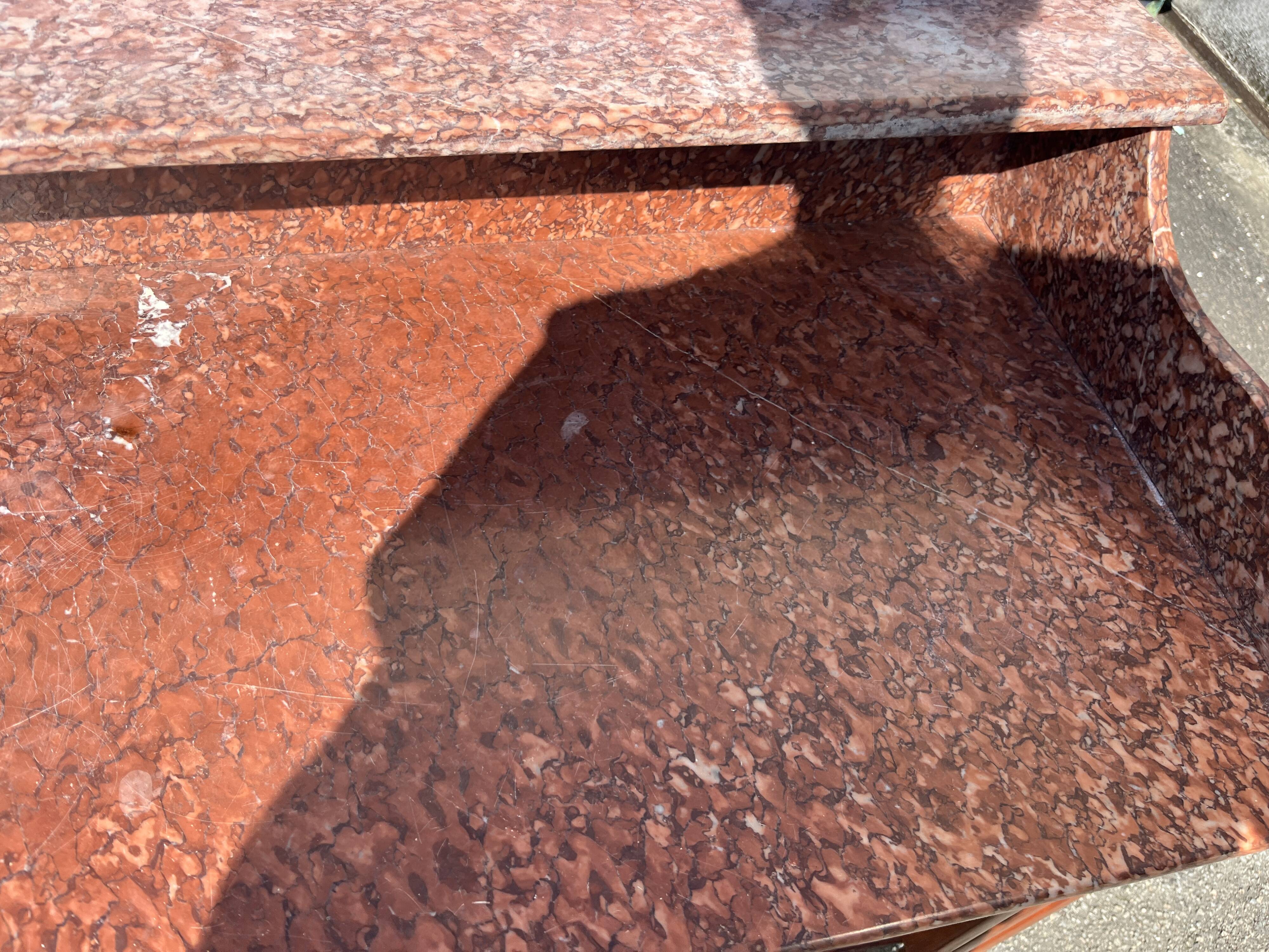 Antique wooden and red marble bathroom cabinet