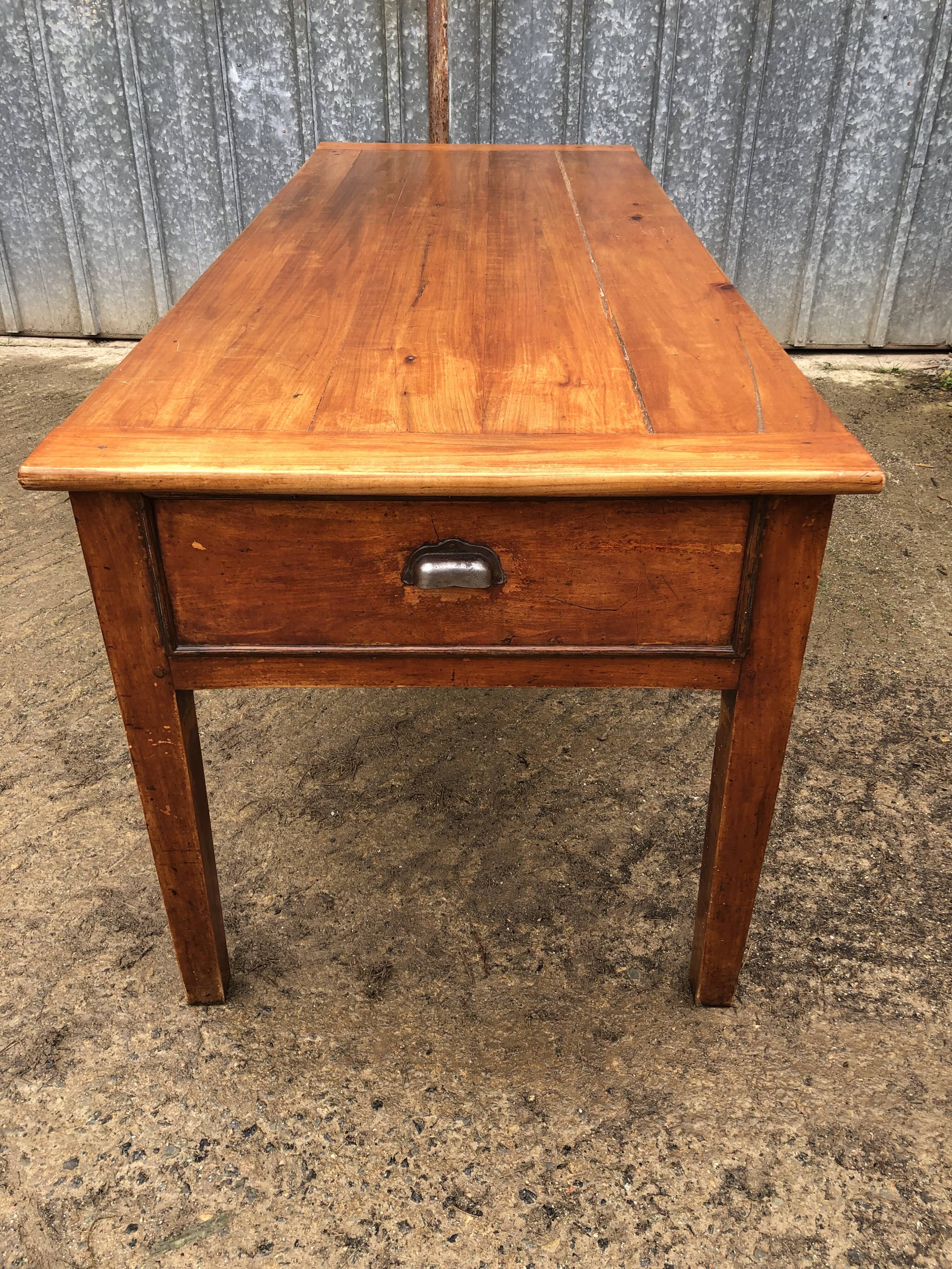 Antique farmhouse table in solid cherry wood with 3 drawers and 1 pull-out.