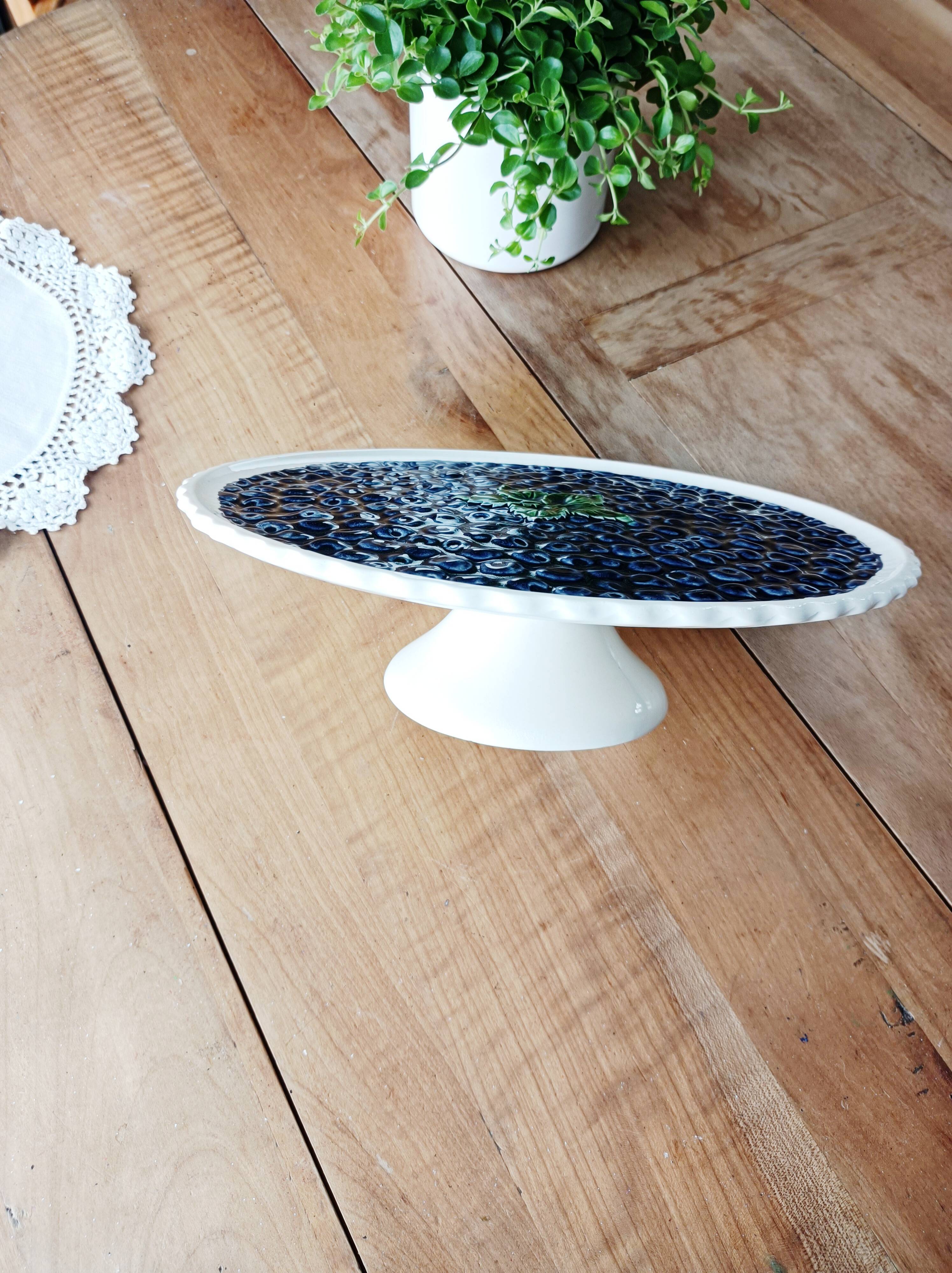 Pie dish on foot, in slip with blackberry decoration