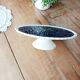 Pie dish on foot, in slip with blackberry decoration