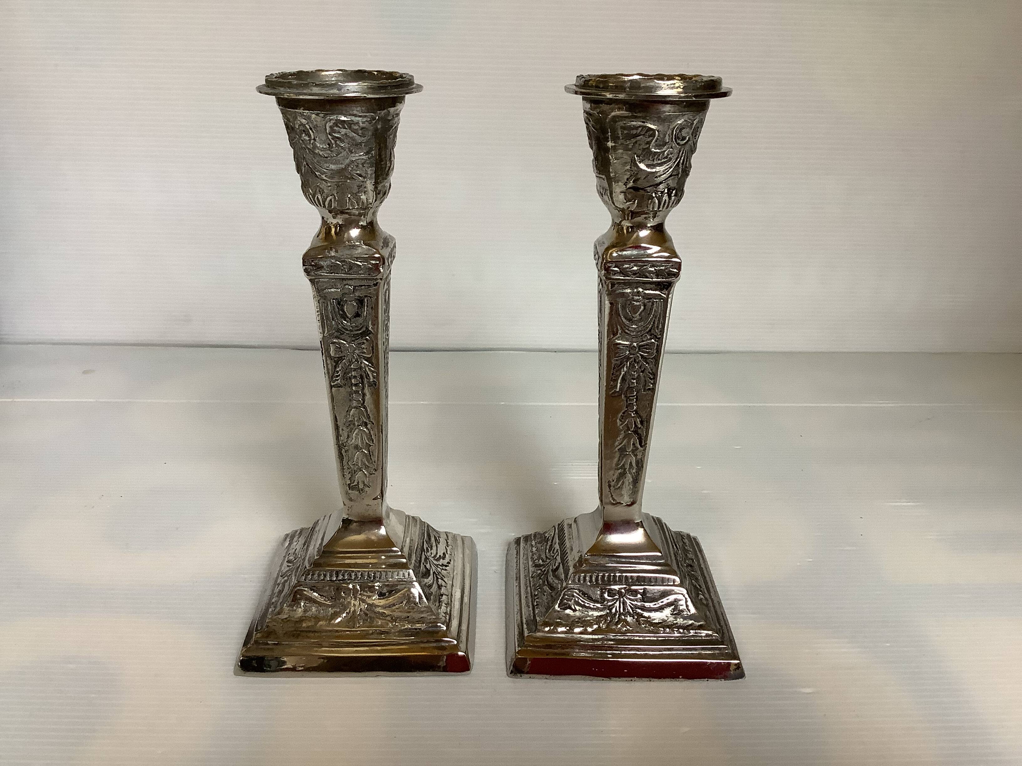 Pair of ornate silver candlesticks