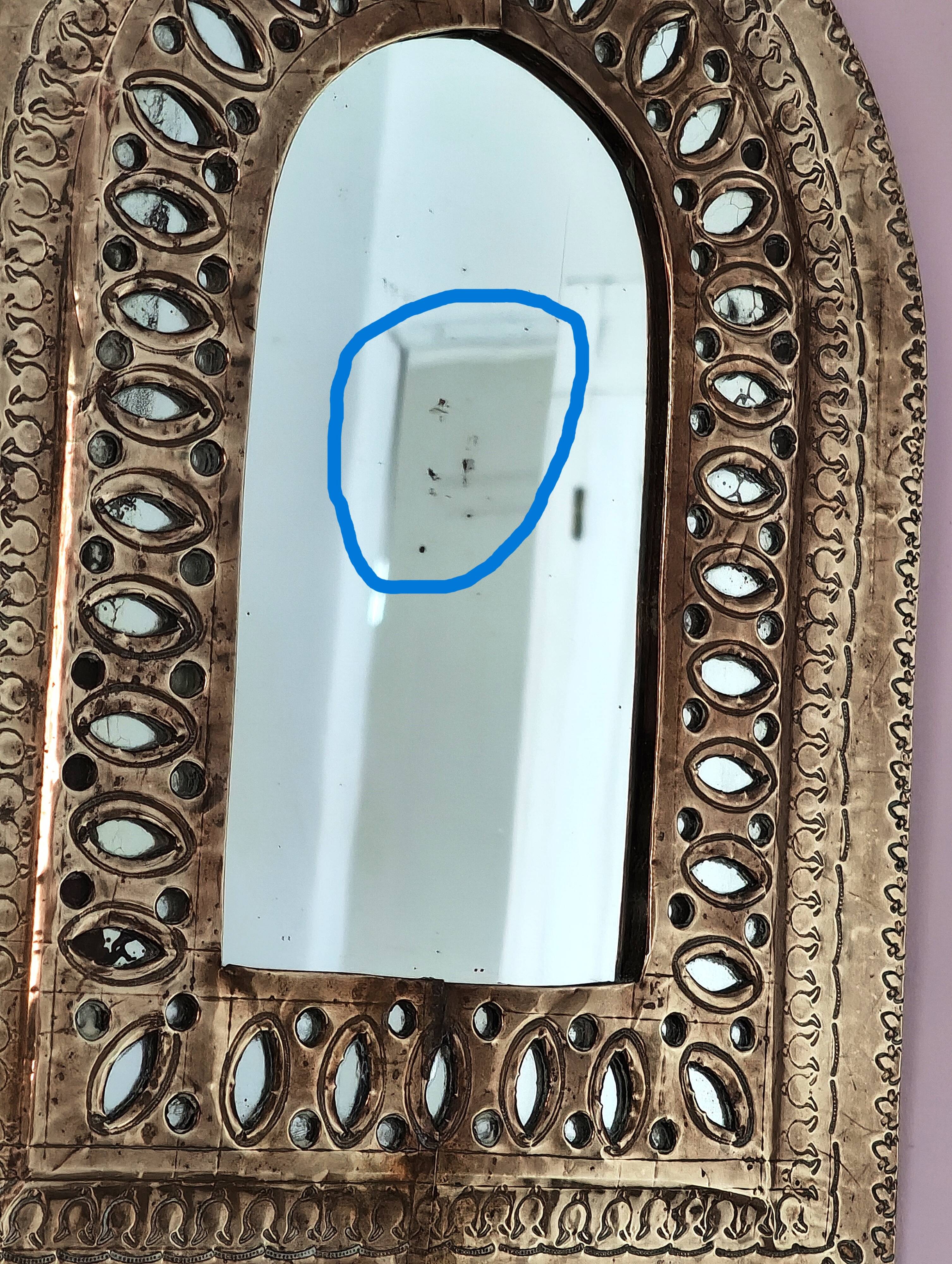 Small golden metal mirror in oriental style.