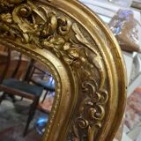 Golden mirror with a flute-playing angel