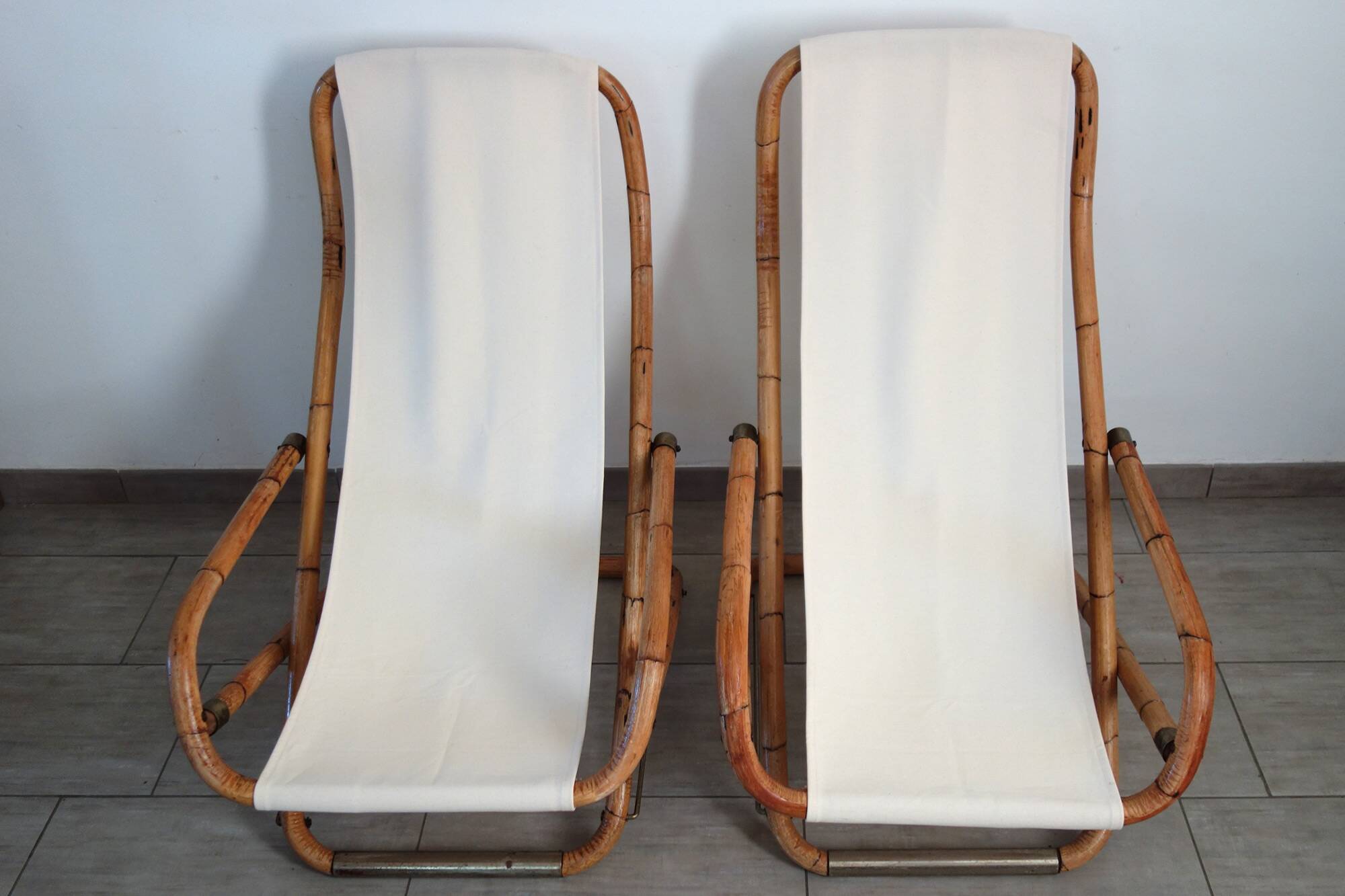 Pair of folding bamboo and brass deck chairs, Italy, 1960s.